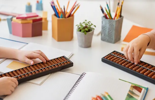Two children practising side by side on wooden sorobans at a table with notebooks and pencils
